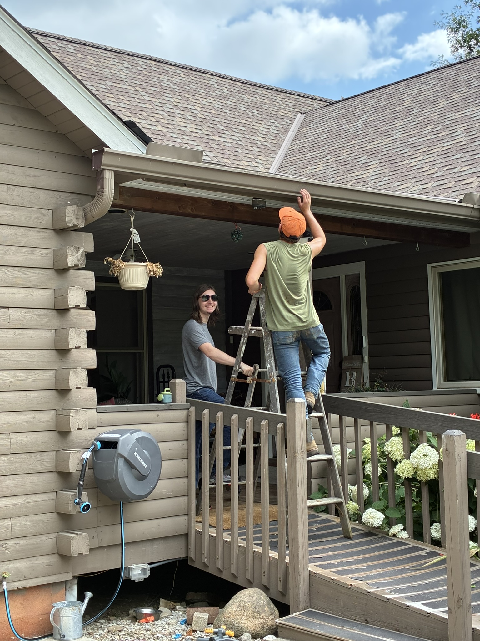 Noah and Gidion cleaning gutters